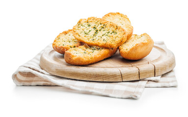Garlic crisp bread Slices Topped With Herbs on cutting board isolated on white background.