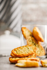 Garlic crisp bread Slices Topped With Herbs on kitchen table.
