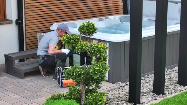 Man Working on Hot Tub in Backyard