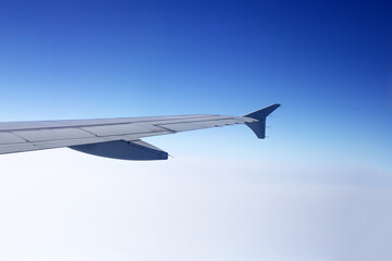 View of sky cloud and wing of airplane from window