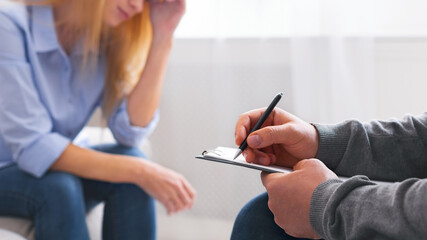 Personal psychological consultation. Depressed woman discussing her problems with therapist,...