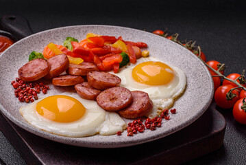 Delicious nutritious breakfast with fried eggs, sausage, steamed vegetables