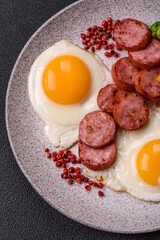 Delicious nutritious breakfast with fried eggs, sausage, steamed vegetables