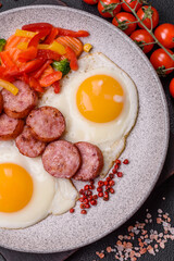 Delicious nutritious breakfast with fried eggs, sausage, steamed vegetables