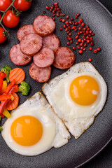 Delicious nutritious breakfast with fried eggs, sausage, steamed vegetables