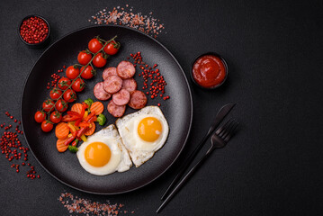 Delicious nutritious breakfast with fried eggs, sausage, steamed vegetables