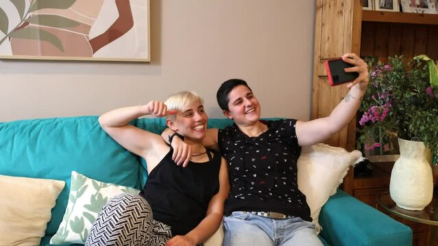 Lesbian Millennials Enjoying Sofa Selfie with smartphone