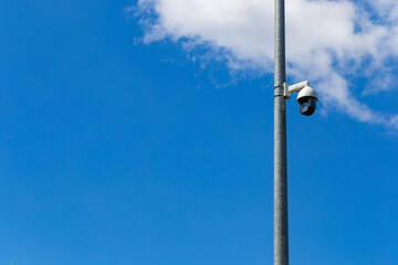 Security camera and urban video in front of blue sky. Outdoor cctv video surveillance cameras....