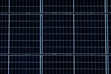 Multiple Solar panels on a warehouse wall.