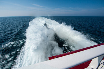 White foamy wake of a large fast catamaran ferry at sea.