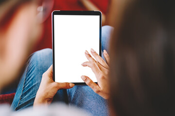 Selective focus on modern touch pad device with copy space display for your internet website.Cropped back view of young marriage typing with finger on blank screen of tablet doing shopping online