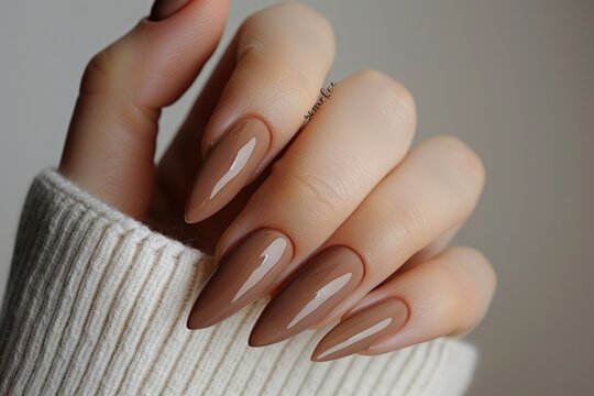 Almond shaped nails painted with brown gel polish AIG51A.