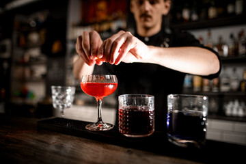 Focus on a high-stemmed glass filled with a cocktail