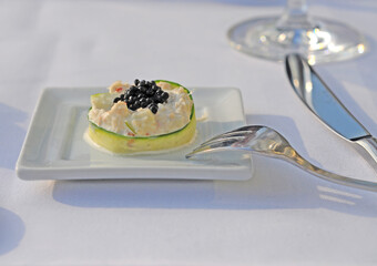 Refined appetizer with zucchini, fish, cauliflower, cream and caviar. Selective focus