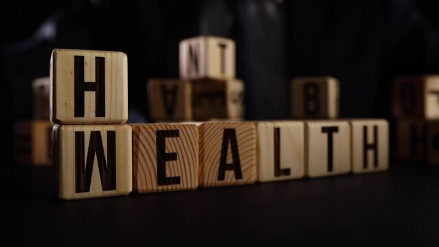 wooden cube with word wealth to health. safety in future and wellbeing