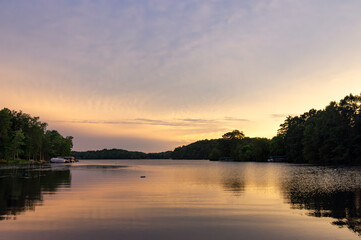 Looking onto a calm Wisconsin lake in the evening as the sun goes down.
