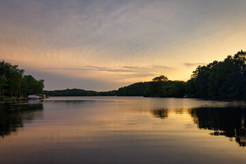 Looking onto a calm Wisconsin lake in the evening as the sun goes down.