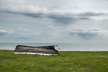 Old fishing boat on the sea shore