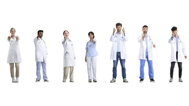 A group of doctors, in full height, on a white background, points forward