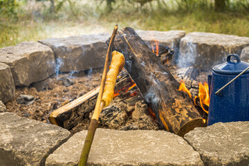 Bannock cooked over a fire inside a tipi