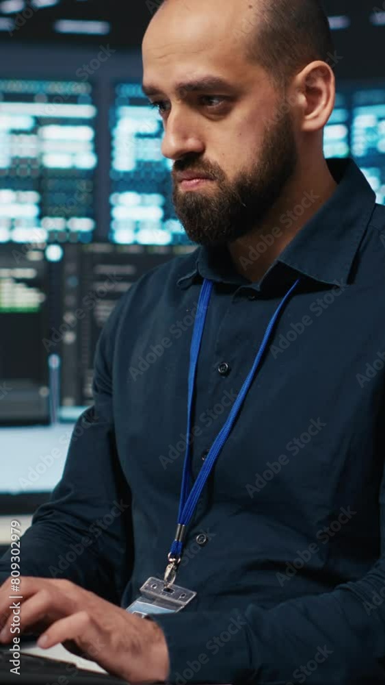 Poster vertical video computer scientist overseeing server hub, typing code on pc, troubleshooting rigs. so