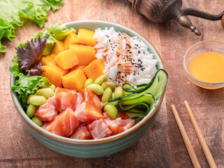 Salmon rice bowl with greens fruits and vegetable. Balance in bowl. Top view.