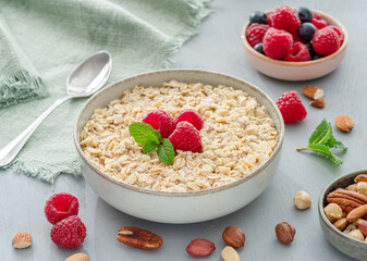 Bowl of porridge or oatmeal with fruits close up. Breakfast concept.