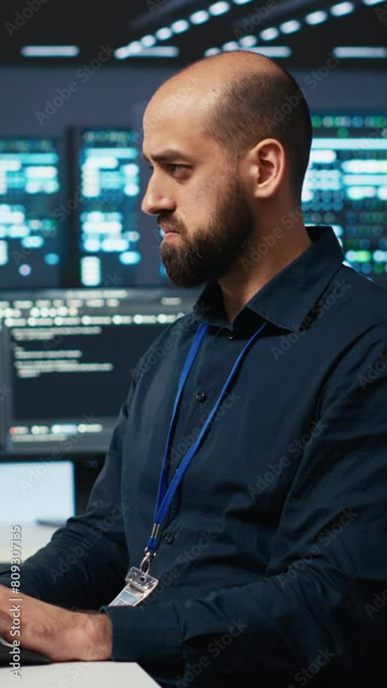 Poster vertical video engineer coding, working in network security data center facility hosting supercomput