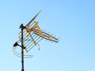 Televisión antenna or TV aerial isolated against a blue Sky with space for text 