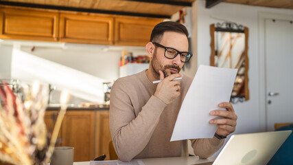 Adult man read and look document work at home paper work