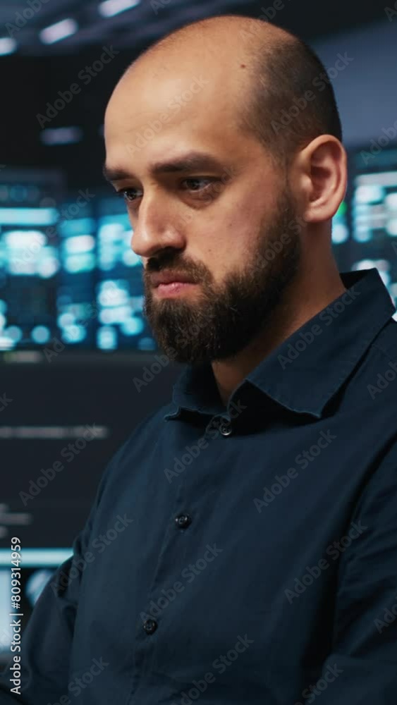 Poster vertical video system admin focused on programming in server farm housing advanced equipment storing