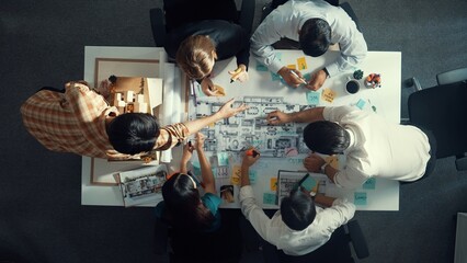 Top aerial view of project manager or civil engineer writing at blueprint and planning building...