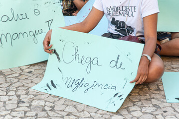 Activists are seen with posters in front of the Barra lighthouse, during a protest against oil...