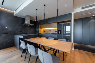 Luxury kitchen and dining room interior with brown parquet floor