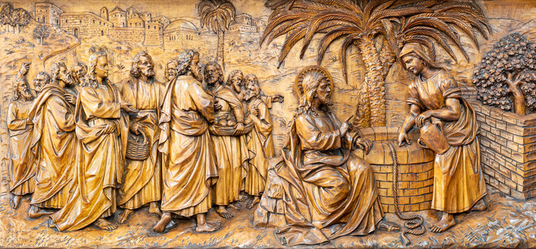 MILAN, ITALY - MARCH 5, 2024: The carved relief of Jesus dialog withe the Samaritan woman in the church Chiesa di San Camillo by Annibale Pagnoni (1900).
