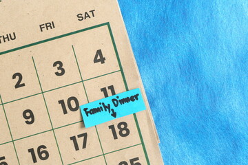 Family dinner on weekends schedule concept. Written reminder note on calendar.