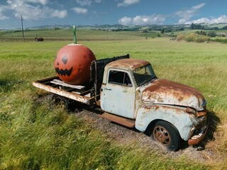 Abandoned rustec pickup truck with giant pumpkin on it. Petaluma, California, United States of America.