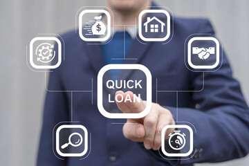 Fototapeta premium Business man working on virtual touch screen presses inscription: QUICK LOAN. Concept of quick and easy loan, fast money providence, business and finance services. Timely payment. Easy instant credit.