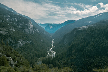 horizontal view of Yosemite valley it mountain range and river.
