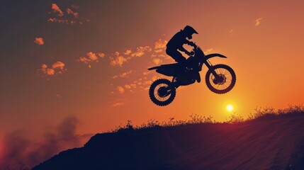 Silhouette Motocross motorcycle jumping on the hill