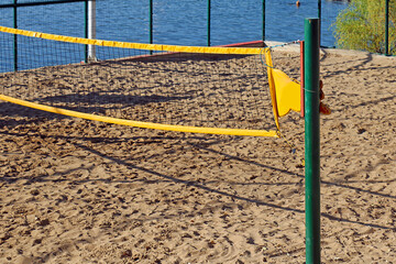 Net for leisure volleyball playing on a beach sand during summer