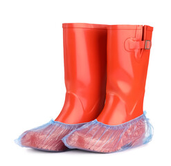 Rubber boots in blue shoe covers isolated on white