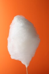 One sweet cotton candy on orange background