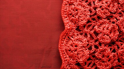 Red textured fabric with intricate lace detailing on one side