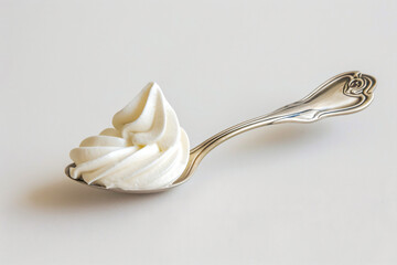 a spoon with whipped cream on it