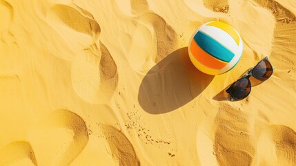 A beach ball and sunglasses are lying on the sandy shore, creating a colorful contrast against the landscape. Its a pictureperfect scene for leisure and recreation AIG50