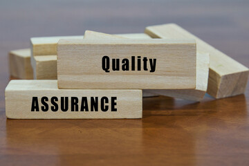 Quality Assurance word on wooden blocks.