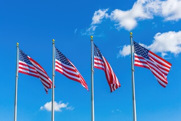 American flags waving in the wind on a background of blue sky.