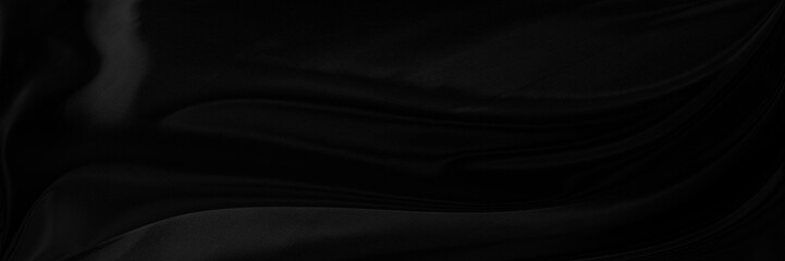 Black gray satin dark fabric texture luxurious shiny that is abstract silk cloth panorama...