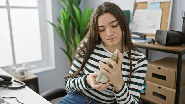 Hispanic woman examines peruvian soles in a modern office setting, reflecting finance or economy.
